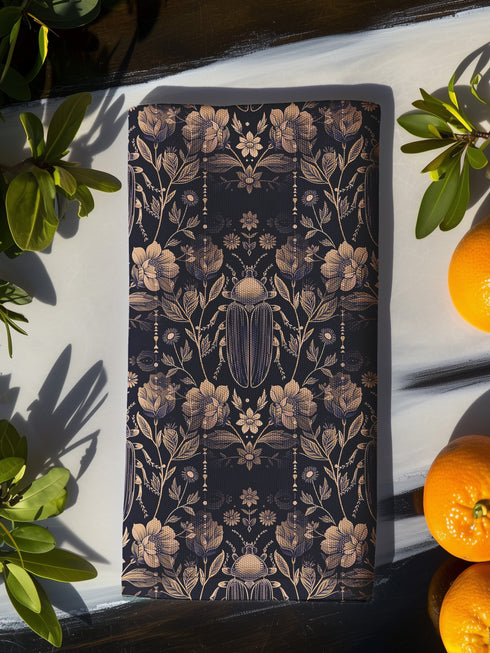 Set of four navy blue dining napkins featuring golden scarab beetles and botanical illustrations in a symmetrical pattern, sized 18x18 inches.